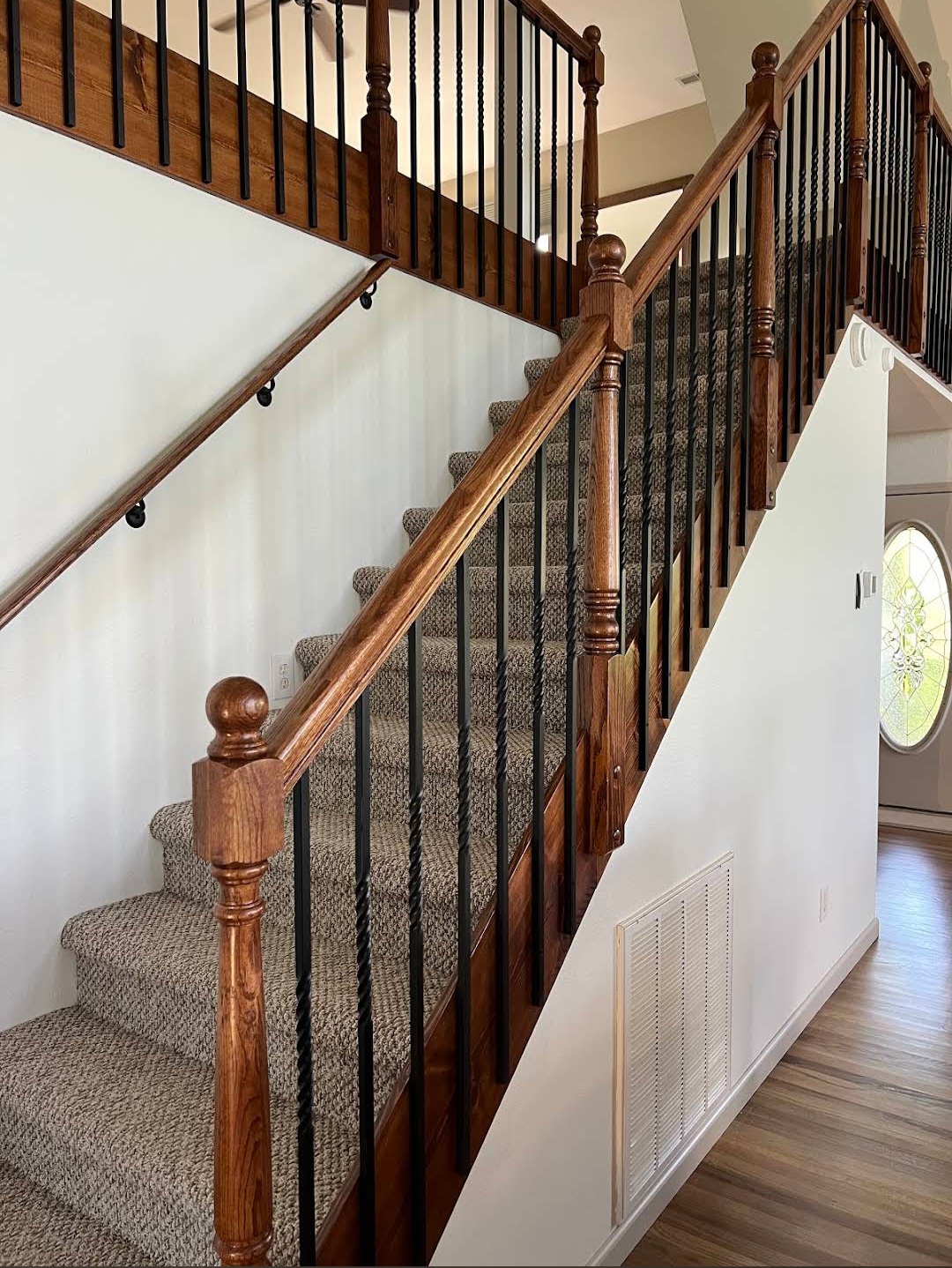 Oak staircase with wrought iron balusters built during a home renovation by W's AllWorks in Cherokee County NC